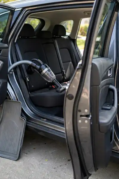 Vacuuming a car interior before freshening