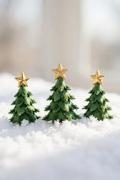 Mini Christmas tree ornaments on faux snow
