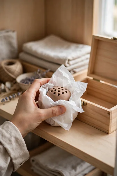 Wrapping clay flower frog for storage