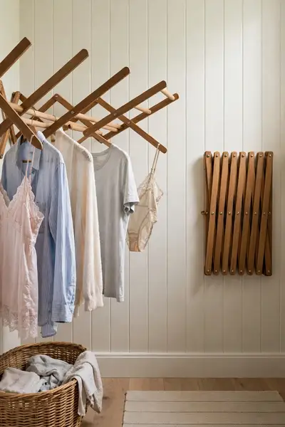 wooden accordion rack with hanging shirts